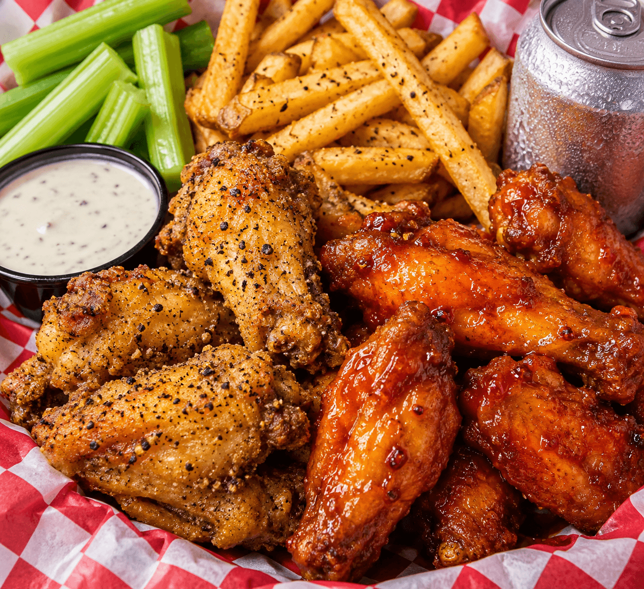 Illustrative lemon-pepper and Honey Hot chicken wings with seasoned fries, celery, and ranch dip